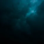 a large body of water under a cloudy sky
