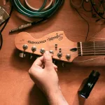 person playing brown electric guitar