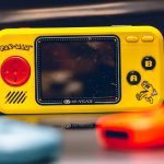 a yellow gameboy sitting on top of a table